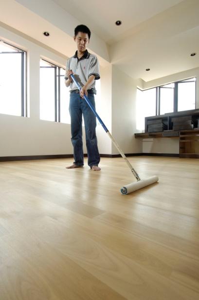 Step 3 – Sanding & Varnishing: applying 1 coat of Strata Base using a floor coater