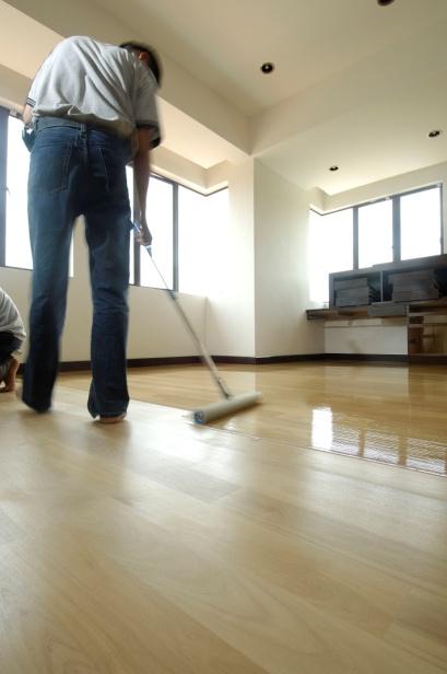 Step 3 – Sanding & Varnishing: applying 2 coats of Strata Pro using a floor coater